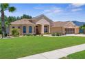 Attractive single-story home with a lush green lawn and well-maintained landscaping creates a charming curb appeal at 13155 Cori Loop, Spring Hill, FL 34609