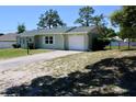 Charming single-story home featuring a well-manicured lawn and a one car attached garage at 13180 Lawrence St, Spring Hill, FL 34609