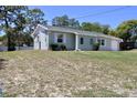 Charming single-story home with a well-manicured front yard and adjacent chain link fence at 13180 Lawrence St, Spring Hill, FL 34609