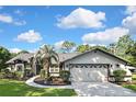 Charming home with a two-car garage, a well-manicured lawn, and professional landscaping enhancing its curb appeal at 13460 Pia Ct, Spring Hill, FL 34609