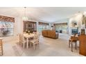 Bright living area featuring neutral walls, carpet, fireplace, and ample seating at 1407 Hickory Moss Pl, Trinity, FL 34655