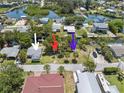 Aerial view of homes with canal access, including indications of properties by colored arrows at 14220 Hendry Ct, Hudson, FL 34667