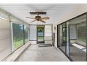 Enclosed patio featuring a ceiling fan, offering a versatile space for relaxation or entertaining at 2443 Glenridge Dr, Spring Hill, FL 34609
