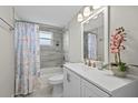 Cozy bathroom featuring shower-tub combination, fresh decor, and neutral tile at 3907 Headsail Dr, New Port Richey, FL 34652