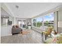 Bright living room with large windows, a coastal-themed rug, and comfortable seating at 3907 Headsail Dr, New Port Richey, FL 34652