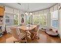 Cozy dining room with hardwood floors, natural light, and views of the water at 4292 Tahiti Dr, Hernando Beach, FL 34607