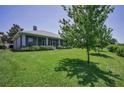 Spacious backyard featuring a screened-in porch, lush green lawn, and mature trees for added privacy at 4485 Gevalia Dr, Brooksville, FL 34604