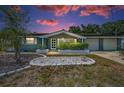 Charming single-story home with mature landscaping, manicured flowerbeds, and an attached two-car garage at 5132 Flora Ave, Holiday, FL 34690