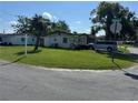 A single Gathering home surrounded by a green lawn on a corner lot at 6315 Hyperion Dr, Port Richey, FL 34668