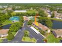 Aerial view showcasing the community's amenities, pond, parking, and lush green surroundings at 6508 Tina Dr # 14, New Port Richey, FL 34653