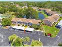 Aerial view of condo with pond view and convenient access to parking at 6508 Tina Dr # 14, New Port Richey, FL 34653