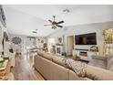 Spacious open-concept living room with modern furnishings, hardwood floors and lots of natural light at 7340 20Th, Zephyrhills, FL 33540