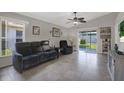 Bright living room with vaulted ceilings, tile floors, and sliding doors to the backyard at 7736 Chadwick Dr, New Port Richey, FL 34654