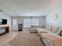 Comfortable living room with a large sectional couch, a window view and modern flooring at 7979 Avenal Loop, New Port Richey, FL 34655