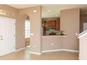 Inviting entryway showcasing an arched opening to the kitchen with ceramic tile flooring at 8409 Blue Rock Dr, New Port Richey, FL 34653