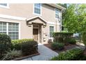 Well maintained townhome entrance with a landscaped walkway and mature shrubbery at 8409 Blue Rock Dr, New Port Richey, FL 34653