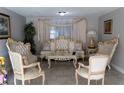 Beautiful living room with ornate furniture, neutral walls, and tile floors at 9116 Gray Fox Ln, Port Richey, FL 34668