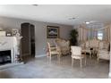 Elegant living room featuring classic furniture, a fireplace, and neutral tile flooring at 9116 Gray Fox Ln, Port Richey, FL 34668