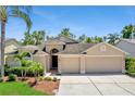 Charming single-Gathering home featuring a three-car garage and mature landscaping at 9729 Bay Colony Dr, Riverview, FL 33578