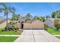 Charming single-Gathering home featuring a three-car garage and mature landscaping at 9729 Bay Colony Dr, Riverview, FL 33578