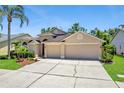 Charming single-Gathering home featuring a three-car garage and mature landscaping at 9729 Bay Colony Dr, Riverview, FL 33578