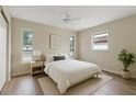 Bright bedroom with a ceiling fan, wood floors, and lots of natural light at 9744 Rainelle Ln, Port Richey, FL 34668