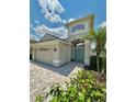 Beautiful home with a paver driveway, a two-car garage, and a beautifully landscaped yard at 9808 Riverchase Dr, New Port Richey, FL 34655