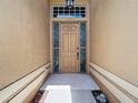 Welcoming front door with sidelights and transom window, offering natural light at 10181 Holly Berry Dr, Weeki Wachee, FL 34613