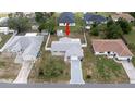 This aerial view highlights the property's location in a quiet neighborhood with fenced backyard and mature landscaping at 10386 Myra St, Spring Hill, FL 34608