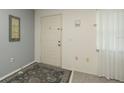 The entryway features neutral walls and flooring with a patterned rug and natural light at 10386 Myra St, Spring Hill, FL 34608