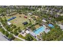 Aerial view of the neighborhood's community park, showcasing a pool, playground, and large open field at 11398 Juglans Dr, Odessa, FL 33556