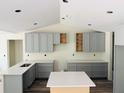 A well-lit kitchen with gray cabinets, modern countertops, and an island, ready for finishing touches at 11406 Labrador Duck Rd, Weeki Wachee, FL 34614