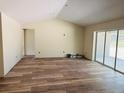 Living room featuring a sliding glass door and modern flooring at 11406 Labrador Duck Rd, Weeki Wachee, FL 34614