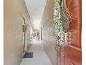 Neutral colored hallway with decoratively textured walls, a white ceiling, and dark brown doors at 11752 Wheatfield Loop, Hudson, FL 34667