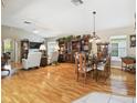 Open-concept living and dining area features hardwood floors and plenty of natural light at 11752 Wheatfield Loop, Hudson, FL 34667