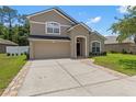 Charming two-story home featuring a neutral color scheme, brick-lined driveway, and an attached garage at 12055 Colony Lakes Blvd, New Port Richey, FL 34654