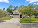 Well-maintained two-story home with manicured lawn, brick accents, and a two-car garage at 12055 Colony Lakes Blvd, New Port Richey, FL 34654
