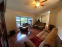 Spacious living room with large windows and comfortable seating area at 12090 Stoneville Ct, Spring Hill, FL 34609