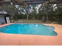 Screened pool with ample deck space perfect for outdoor relaxation and entertainment at 12090 Stoneville Ct, Spring Hill, FL 34609
