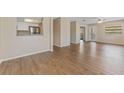 Open-concept living room featuring durable laminate flooring and natural light at 12155 Environmental Dr # 8, New Port Richey, FL 34654