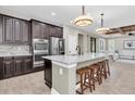 Modern kitchen with stainless steel appliances, granite countertops, and a large island with seating at 12420 Rangeland Blvd, Odessa, FL 33556