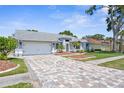 Lovely single-story home with a spacious driveway, a two-car garage, and beautifully landscaped front yard at 1245 Overland Dr, Spring Hill, FL 34608