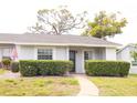 Inviting home featuring manicured hedges, a well-kept lawn, and a paved walkway to the front entrance at 12511 Dearborn Dr, Hudson, FL 34667