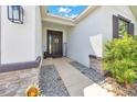 Inviting front entrance with decorative sunflower wreath, 'WELCOME' sign, and textured stone accents at 13454 Golden Lime Ave, Spring Hill, FL 34609