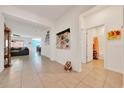 Open hallway with tile flooring, neutral paint, and views to living areas, and an adorable statue at 13454 Golden Lime Ave, Spring Hill, FL 34609