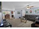 Spacious living room with wood floors, a ceiling fan, and bright, neutral paint at 13923 Pathfinder Dr, Tampa, FL 33625