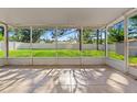 Relaxing screened patio overlooks a spacious backyard with lush green grass at 13935 Coronado Dr, Spring Hill, FL 34609