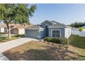 Inviting home featuring a two-car garage and a manicured lawn with decorative landscaping at 15159 Durango Cir, Brooksville, FL 34604