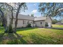 Well-maintained single Gathering home with a green lawn and mature landscaping, featuring a side entry garage at 15613 Charmwood Dr, Hudson, FL 34667