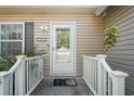 Inviting front entrance with a decorative glass door, sidelights, and a well-maintained porch at 15613 Charmwood Dr, Hudson, FL 34667